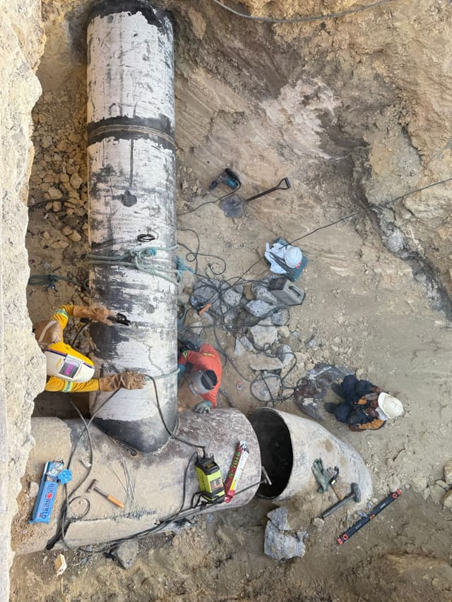 Workers executing emergency bypass plan.