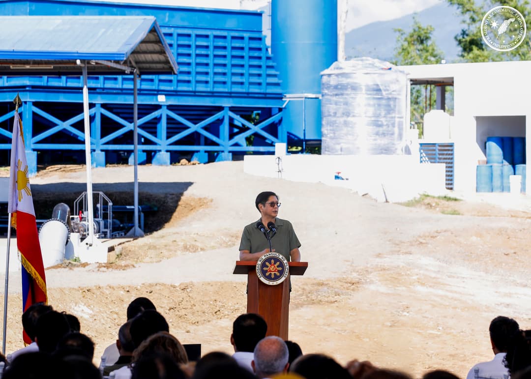 The president of the Philippines giving a speech in-front of a crowd.